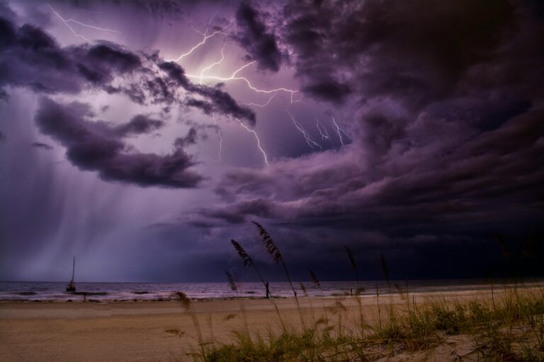 Dramatic lightning bolts illuminate the night sky over Redington Beach, creating a stunning natural scene.